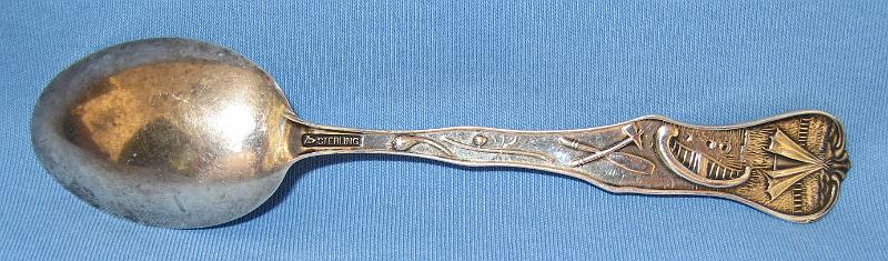 Souvenir Mining Spoon Calumet Hecla Mine Reverse.JPG - SOUVENIR MINING SPOON CALUMET & HECLA SHAFT NO 2 CALUMET MICHIGAN - Sterling souvenir mining spoon, 5 1/2 in. long, embossed mining scene in bowl, marked CALUMET & HECLA SHAFT NO. 2, CALUMET, MICH., handle with MI state seal at top and miner with pick, marked MICHIGAN, reverse shows designs of teepee and canoe with Sterling stamping and makers mark, ex-John Rascona collection [In 1864, Edwin J. Hulbert discovered a copper-bearing section of what became known as the Calumet Conglomerate in Houghton County, Michigan. Hulbert formed the Calumet Company in 1865, with Boston investors. The company spun off the Hecla Company the following year, and assigned shares in the new company to Calumet shareholders.  Hulbert was a major shareholder in both companies, and was in charge of mine operations. But despite the rich ore, Hulbert did not have the practical knowledge to dig out the ore, crush it, and concentrate it. Frustrated with Hulbert’s lack of success, the company sent Alexander Agassiz to run the mine.  Under Agassiz’ expert management, the Hecla Company paid its first dividend in 1868, and the Calumet Company began paying dividends in 1869. The two companies merged in May 1871 to form the Calumet & Hecla Mining Company, with Quincy Adams Shaw as its first president. In August of that year, Shaw retired to the board of directors and Agassiz became president, a position he held until his death. The town of Red Jacket (now named Calumet) formed next to the mine.  Calumet and Hecla built itself into a copper mining colossus. From 1868 through 1886, it was the leading copper producer in the United States, and from 1869 through 1876, the leading copper producer in the world.  From 1871 through 1880, Calumet and Hecla turned out more than half the copper produced in the United States. In each year save one between 1870 and 1901, Calumet and Hecla made most of the copper produced in the Michigan copper district.  By 1901 the underground mining complex had 16 shafts. Annual copper production from the mines peaked in 1906 at 100 million pounds then declined to 67 million pounds by 1912 in response to lower prices.  Copper prices fell drastically after WW I and the company shut down mining on the Calumet conglomerate in April 1921.  Copper production rebounded in 1922, and rose steadily through the 1920s. Calumet and Hecla grew in the 1920s by buying and merging with neighboring copper mines. In 1923, Calumet and Hecla merged with the Ahmeek, Allouez, and Centennial mining companies. The combined entity was renamed the Calumet and Hecla Consolidated Copper Company. The merged company essentially controlled all the operating copper mines north of Hancock, Michigan.  During the Great Depression, copper prices dropped, and as a result most copper mines in the Copper Country closed, including Calumet and Hecla. Following WW II, the company resumed operations but was unable to produce enough copper for its internal uses. Universal Oil Products bought Calumet and Hecla in April 1968. The company shut down the dewatering pumps in 1970 and the mines have remained idle ever since, and most are permanently capped.  Today, many Calumet and Hecla company mines and buildings are part of Keweenaw National Historical Park.]